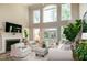 Bright living room offers large windows, a fireplace, and plush seating for relaxation at 9136 Palm Bay Cir, Raleigh, NC 27617