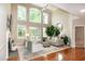 Spacious living room with large windows, hardwood floors, and comfortable seating arrangements at 9136 Palm Bay Cir, Raleigh, NC 27617