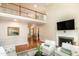 Open-concept living area with hardwood floors, fireplace, and access to the upstairs balcony at 9136 Palm Bay Cir, Raleigh, NC 27617