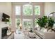 Bright living room with fireplace, large windows, and comfortable seating area at 9136 Palm Bay Cir, Raleigh, NC 27617
