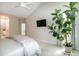 Bright main bedroom featuring vaulted ceilings, a modern ceiling fan, and a wall-mounted television at 9136 Palm Bay Cir, Raleigh, NC 27617