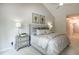 Bedroom featuring neutral carpet, large bed, bedside lamps, and a ceiling fan at 9136 Palm Bay Cir, Raleigh, NC 27617