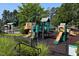 Community playground with multiple slides, climbing areas, and soft landing surfaces, ideal for recreation at 9136 Palm Bay Cir, Raleigh, NC 27617
