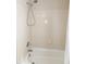 Shower and tub with tiled surround and shower head at 9136 Palm Bay Cir, Raleigh, NC 27617