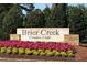 Entrance sign for Brier Creek Country Club with flowers at 9136 Palm Bay Cir, Raleigh, NC 27617