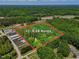 Expansive aerial view showcasing the +/- 5.28 acre lot surrounded by lush greenery and mature trees at 9257 Sauls Rd, Raleigh, NC 27603