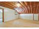 Unfinished attic space with insulation, exposed beams, and a window for potential customization at 9257 Sauls Rd, Raleigh, NC 27603