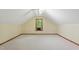 Spacious attic with neutral carpet, centered window and natural light, perfect for storage or conversion at 9257 Sauls Rd, Raleigh, NC 27603