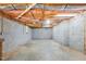 Unfinished basement, cinder block walls, with exposed beams, plumbing and wiring at 9257 Sauls Rd, Raleigh, NC 27603