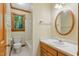 Bathroom featuring a vanity, toilet, and a shower-tub combination by a bright window at 9257 Sauls Rd, Raleigh, NC 27603
