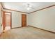 Large bedroom features tan carpet, neutral paint, wood trim, ceiling fan and closet at 9257 Sauls Rd, Raleigh, NC 27603