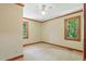 Bedroom featuring two windows with natural light and views of greenery outside at 9257 Sauls Rd, Raleigh, NC 27603