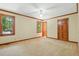 Spacious bedroom features tan carpet, neutral paint, wood trim, ceiling fan and windows at 9257 Sauls Rd, Raleigh, NC 27603