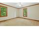 Bedroom bathed in natural light with wood trim and a view of the surrounding trees at 9257 Sauls Rd, Raleigh, NC 27603
