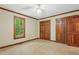 Bedroom featuring a window with a view and closet, complemented by a ceiling fan at 9257 Sauls Rd, Raleigh, NC 27603