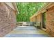 View of deck area surrounded by brick and trees at 9257 Sauls Rd, Raleigh, NC 27603