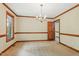 Bright dining room featuring hardwood trim and a chandelier at 9257 Sauls Rd, Raleigh, NC 27603