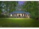 Charming brick home featuring a covered porch with stately columns and manicured landscaping at 9257 Sauls Rd, Raleigh, NC 27603