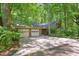 Home with a two-car garage, extended driveway, and mature trees at 9257 Sauls Rd, Raleigh, NC 27603