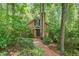 Charming brick home featuring a brick walkway and lush landscaping at 9257 Sauls Rd, Raleigh, NC 27603