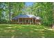 Beautiful brick home with a welcoming front porch and lush green lawn at 9257 Sauls Rd, Raleigh, NC 27603
