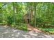 Brick home with a brick walkway surrounded by mature trees at 9257 Sauls Rd, Raleigh, NC 27603