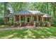 Inviting front porch with classic brickwork, stately columns, and a well-manicured lawn at 9257 Sauls Rd, Raleigh, NC 27603