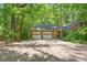 Spacious two-car garage with an extended driveway and mature trees at 9257 Sauls Rd, Raleigh, NC 27603
