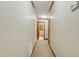 Hallway featuring warm carpeting and wood trim leading to a bathroom and other rooms at 9257 Sauls Rd, Raleigh, NC 27603