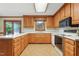 Kitchen with oak cabinets, tile floor, and white countertops at 9257 Sauls Rd, Raleigh, NC 27603