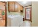 Laundry room with cabinetry and countertop space and backyard access at 9257 Sauls Rd, Raleigh, NC 27603