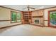 Cozy living room featuring a brick fireplace and built-in wooden shelving at 9257 Sauls Rd, Raleigh, NC 27603