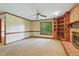Living room featuring built in shelving, large window, and neutral carpeting at 9257 Sauls Rd, Raleigh, NC 27603