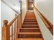 Elegant wooden staircase leading to the upper level with a view of the unfinished attic space at 9257 Sauls Rd, Raleigh, NC 27603