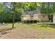 Back exterior view of home features outdoor deck, backyard, shed, and adirondack chairs at 9507 Sertoma Rd, Chapel Hill, NC 27516
