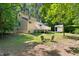Back exterior view of home with spacious backyard, shed, patio furniture, and a wooden deck at 9507 Sertoma Rd, Chapel Hill, NC 27516