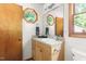 Bathroom with unique octagonal windows, wooden vanity, and plenty of natural light at 9507 Sertoma Rd, Chapel Hill, NC 27516
