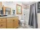 Bright bathroom features tile flooring, wooden vanity, tub and shower combination, plus a window view at 9507 Sertoma Rd, Chapel Hill, NC 27516