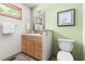 Charming bathroom featuring a wooden vanity, neutral tiles, and natural light from the window at 9507 Sertoma Rd, Chapel Hill, NC 27516