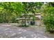 Exterior view of the home nestled among trees, showcasing the natural surroundings at 9507 Sertoma Rd, Chapel Hill, NC 27516
