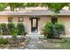 Inviting entrance with a stylish door, complemented by lush landscaping at 9507 Sertoma Rd, Chapel Hill, NC 27516