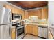 Well-equipped kitchen boasts stainless steel appliances, tile backsplash, and ample wood cabinetry at 9507 Sertoma Rd, Chapel Hill, NC 27516