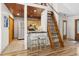 Open-concept kitchen features stainless steel appliances, breakfast bar, and striking wood ceiling detail at 9507 Sertoma Rd, Chapel Hill, NC 27516