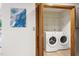 Convenient laundry area with side-by-side washer and dryer and useful overhead shelving at 9507 Sertoma Rd, Chapel Hill, NC 27516