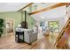 Open-concept living room with vaulted ceilings, exposed beams, and natural light at 9507 Sertoma Rd, Chapel Hill, NC 27516