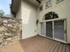 Back porch featuring wooden decking and natural stone siding near a sliding glass door at 95113 Vance Knls, Chapel Hill, NC 27517