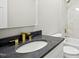 Modern bathroom with white vanity, granite countertop, gold faucet, and white tile at 95113 Vance Knls, Chapel Hill, NC 27517