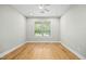 Bright, empty bedroom with hardwood floors and a large window, ready for personalization at 95113 Vance Knls, Chapel Hill, NC 27517