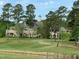 Beautiful clubhouse on a lush green golf course with mature trees and landscaping at 95113 Vance Knls, Chapel Hill, NC 27517