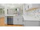 Open kitchen with white cabinets, stainless appliances, and a seamless flow to the living area at 95113 Vance Knls, Chapel Hill, NC 27517